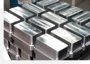 Stacked metallic blocks arranged in rows, viewed from above.