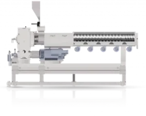 An industrial extrusion machine with a long screw barrel, feed intake, and multiple components mounted on a sturdy base. The machine is designed for processing materials by forcing them through a die.