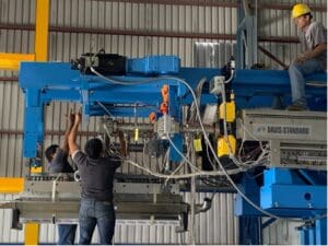A group of people working on an overhead crane.